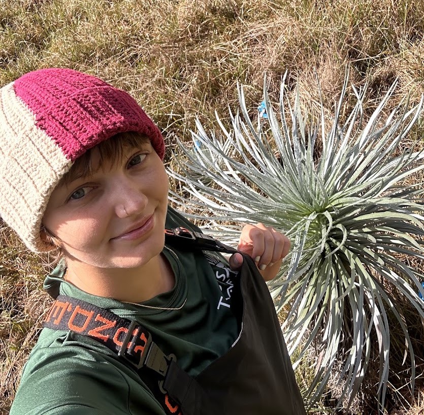 Ariel smiling next to an 'ahinahina plant, also known at the Hawai'i silversword.