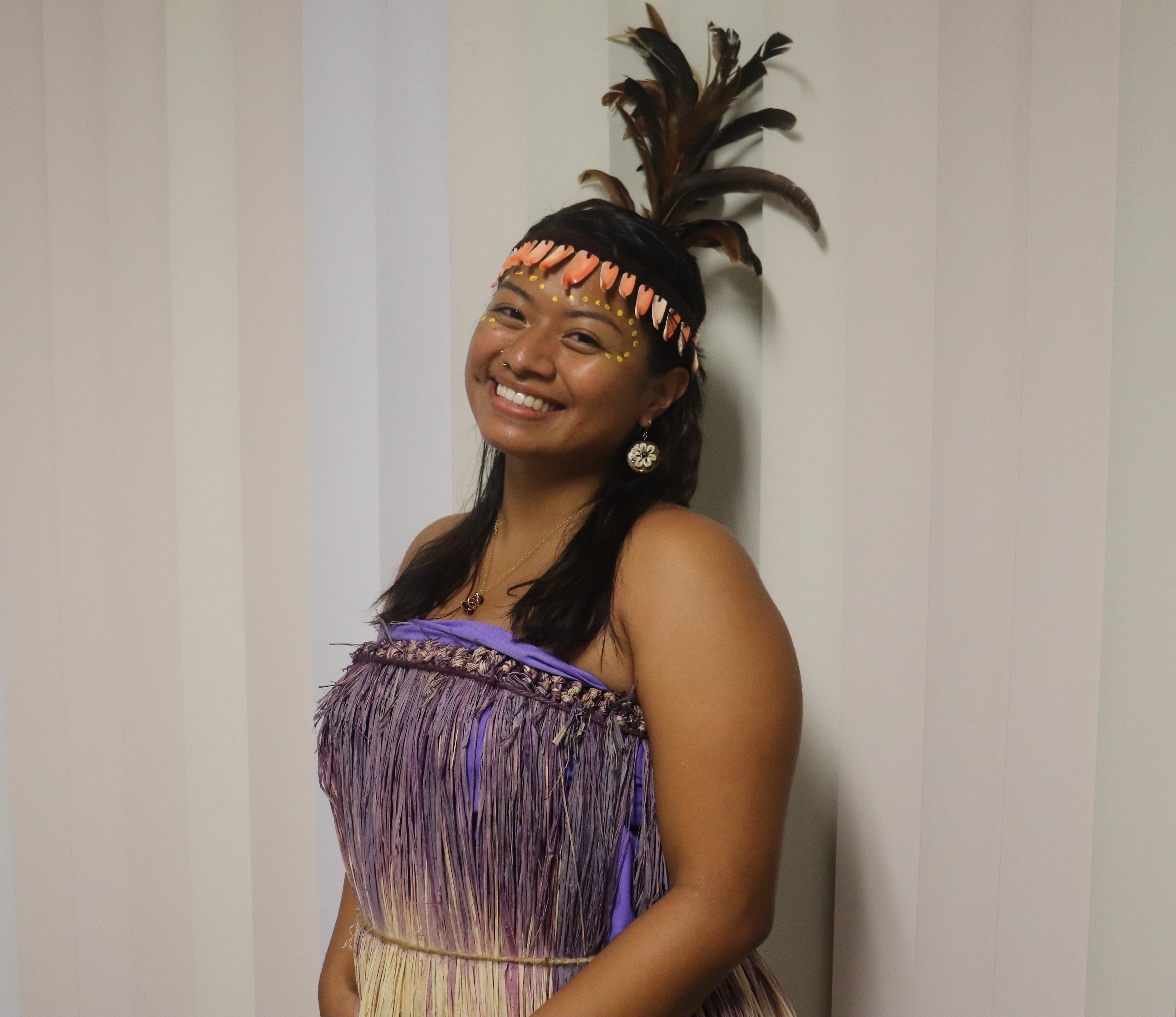 Mio smiles while dressed in traditional Papua New Guinean attire