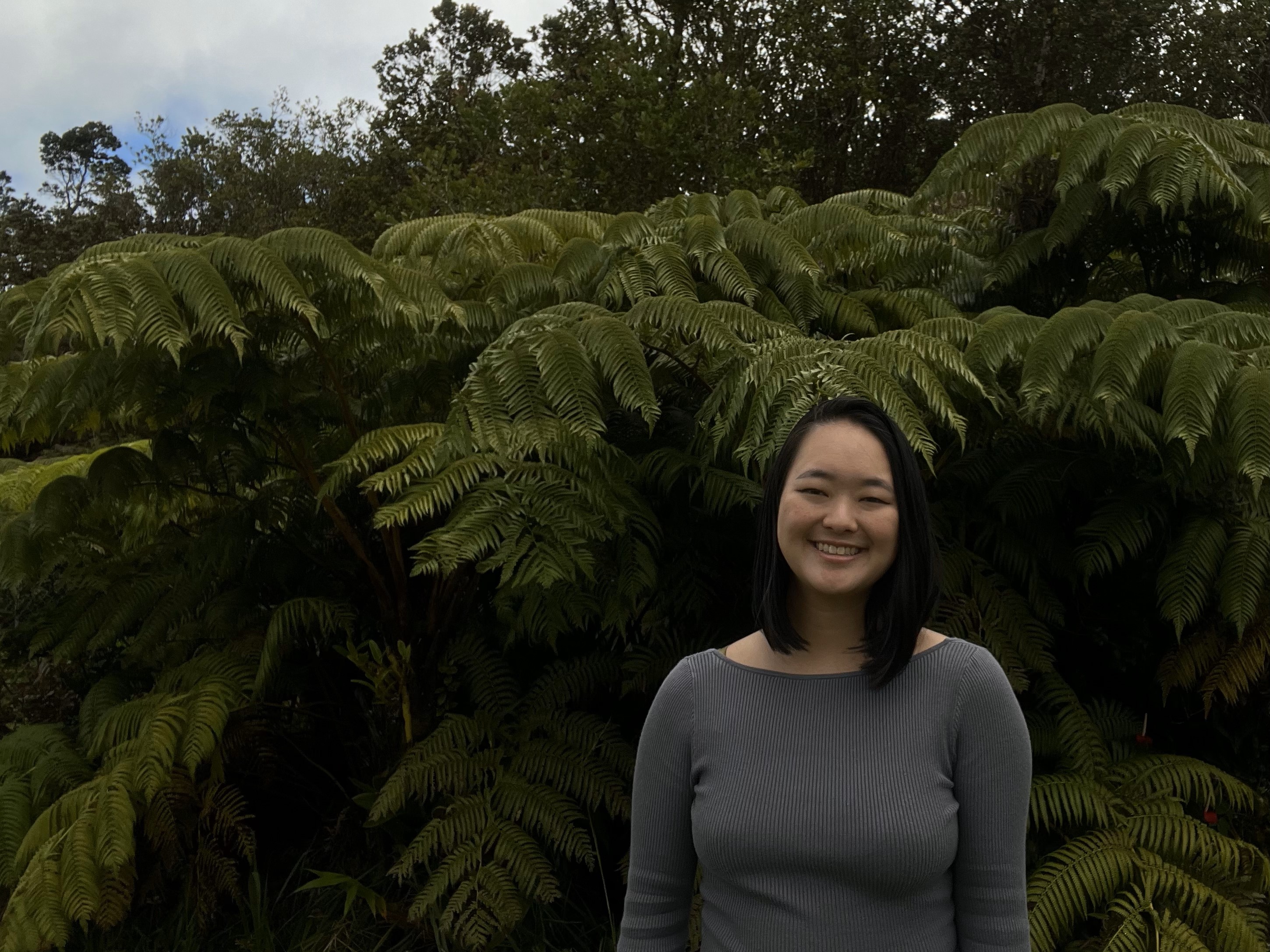Headshot of Nai'a standing in front of Hapu'u ferns
