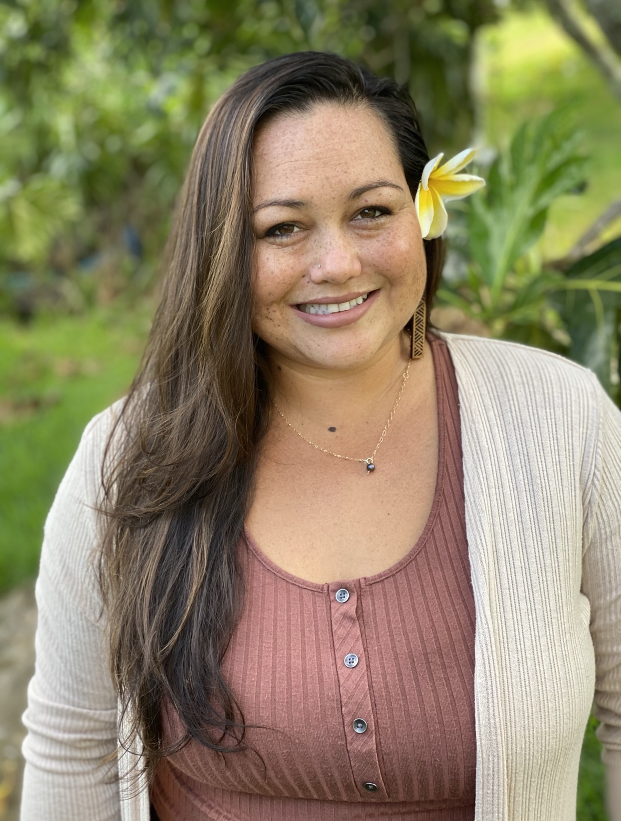 Headshot of Amber with a flower behind her ear